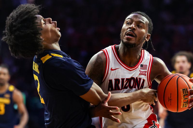 Jan 24, 2026; Tucson, Arizona, USA; Arizona Wildcats guard Jaden Bradley (0) receives a charging foul after knocking over West Virginia Mountaineers guard Amir Jenkins (2) during the second half of the game at McKale Memorial Center. Mandatory Credit: Aryanna Frank-Imagn Images