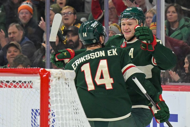 Dec 14, 2025; Saint Paul, Minnesota, USA; Minnesota Wild forward Kirill Kaprizov (97) celebrates after his goal against the Boston Bruins with forward Joel Eriksson Ek (14) during the second period at Grand Casino Arena. Mandatory Credit: Nick Wosika-Imagn Images