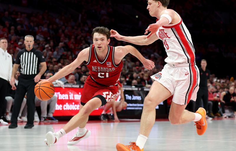 Jan 5, 2026; Columbus, Ohio, USA;  Nebraska Cornhuskers forward Pryce Sandfort (21) drives to the basket as Ohio State Buckeyes center Christoph Tilly (13) defends during the first half at Value City Arena. Mandatory Credit: Joseph Maiorana-Imagn Images