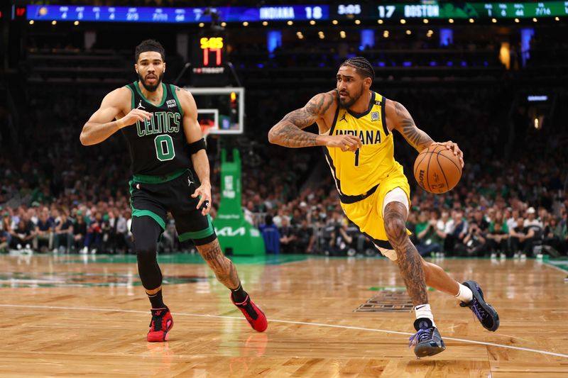 BOSTON, MASSACHUSETTS - MAY 23: Obi Toppin #1 of the Indiana Pacers drives past Jayson Tatum #0 of the Boston Celtics during the first quarter in Game Two of the Eastern Conference Finals at TD Garden on May 23, 2024 in Boston, Massachusetts. NOTE TO USER: User expressly acknowledges and agrees that, by downloading and or using this photograph, User is consenting to the terms and conditions of the Getty Images License Agreement. (Photo by Maddie Meyer/Getty Images)