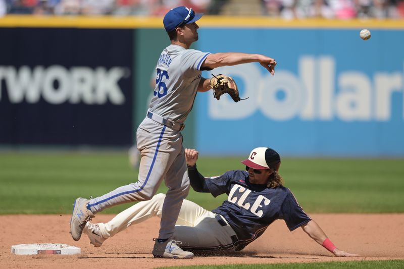 Jun 6, 2024; Cleveland, Ohio, USA; Kansas City Royals second baseman Adam Frazier (26) forces out Cleveland Guardians shortstop Daniel Schneemann (10) and turns the double play during the eighth inning at Progressive Field. Mandatory Credit: Ken Blaze-USA TODAY Sports