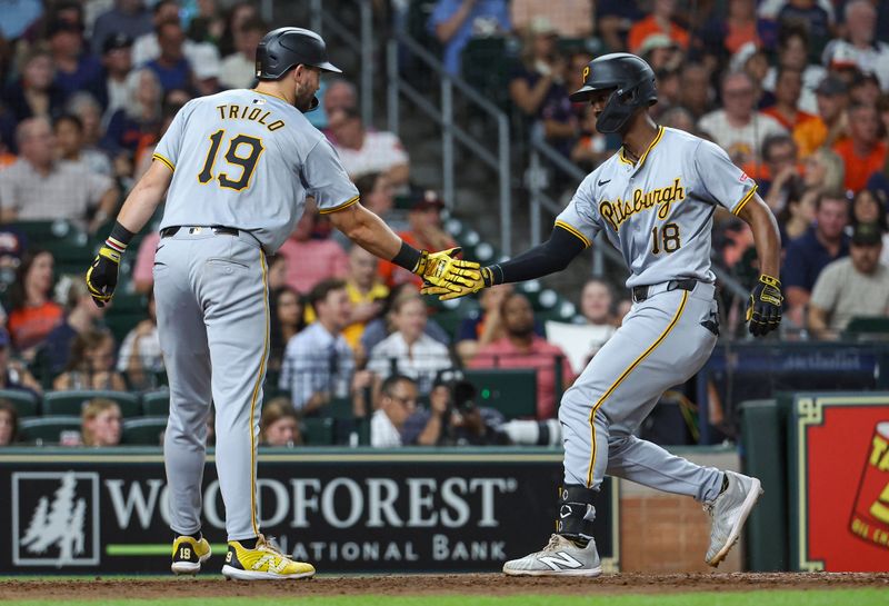 Jul 30, 2024; Houston, Texas, USA; Pittsburgh Pirates center fielder Michael A. Taylor (18) celebrates with second baseman Jared Triolo (19) after hitting a home run during the sixth inning against the Houston Astros at Minute Maid Park. Mandatory Credit: Troy Taormina-USA TODAY Sports