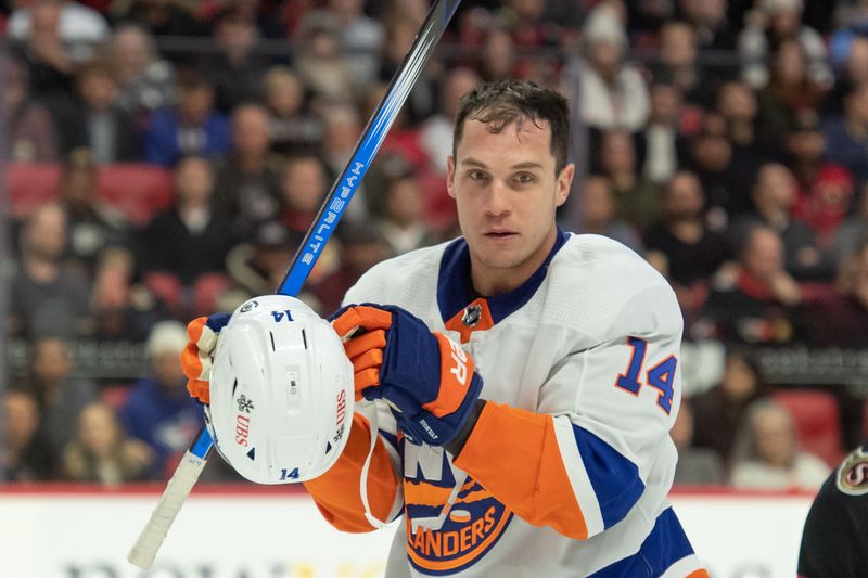 Nov 24, 2023; Ottawa, Ontario, CAN; New York Islanders center Bo Horvat (14) loses his helmet during game action in the second period against the Ottawa Senators at the Canadian Tire Centre. Mandatory Credit: Marc DesRosiers-USA TODAY Sports