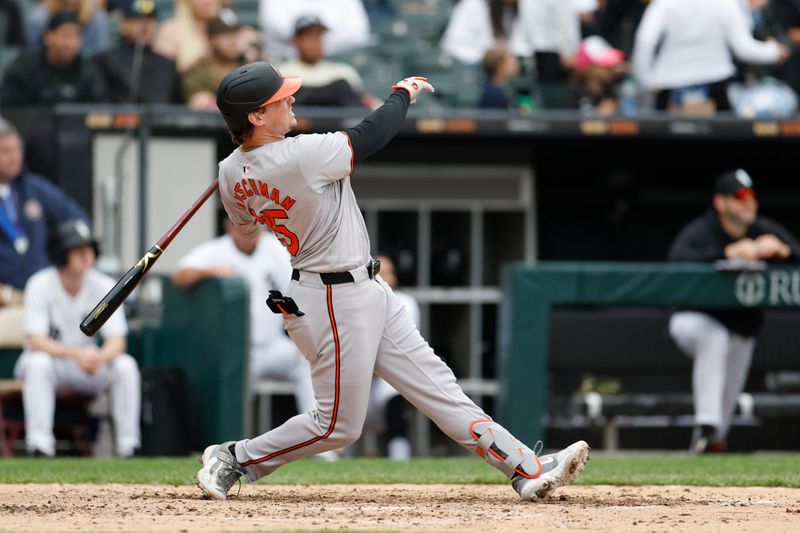 May 26, 2024; Chicago, Illinois, USA; Baltimore Orioles catcher Adley Rutschman (35) hits a two-run home run against the Chicago White Sox during the sixth inning at Guaranteed Rate Field. Mandatory Credit: Kamil Krzaczynski-USA TODAY Sports