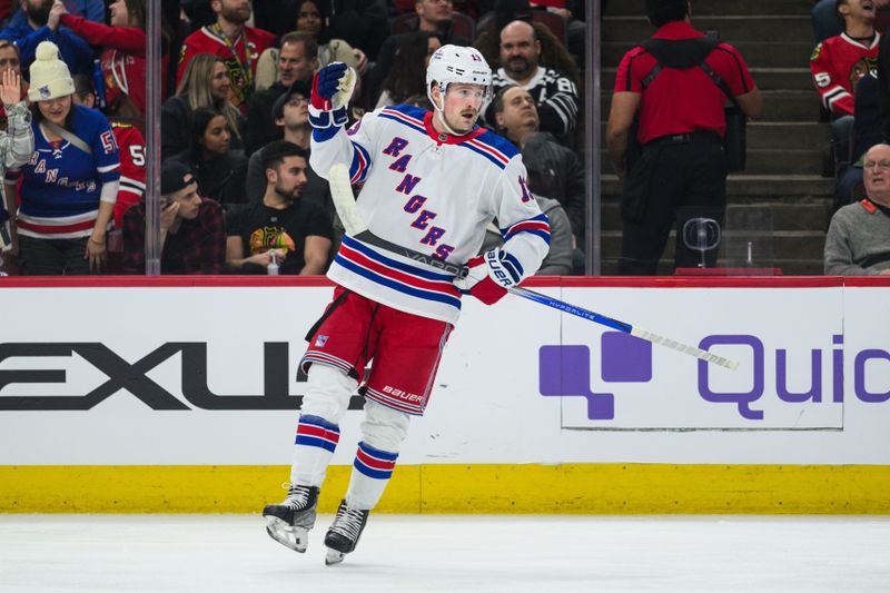 Feb 9, 2024; Chicago, Illinois, USA; New York Rangers left wing Alexis Lafreniere (13) celebrates his goal with teammates against the Chicago Blackhawks during the first period at the United Center. Mandatory Credit: Daniel Bartel-USA TODAY Sports