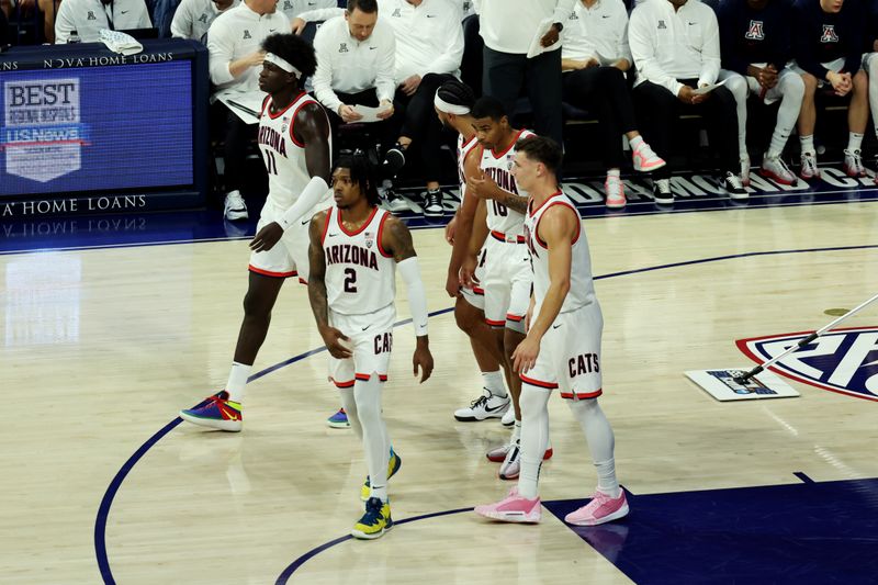 Dec 2, 2023; Tucson, Arizona, USA; Arizona Wildcats guard Caleb Love (2), center Oumar Ballo (11), forward Keshad Johnson (16), guard Pelle Larsson (3), and guard Kylan Boswell (4) walk back onto the court after a timeout during the first half at McKale Center. Mandatory Credit: Zachary BonDurant-USA TODAY Sports