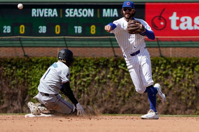 Apr 21, 2024; Chicago, Illinois, USA; Chicago Cubs shortstop Dansby Swanson (7) forces out Miami Marlins outfielder Nick Gordon (1) at second base during the fourth inning at Wrigley Field. Mandatory Credit: David Banks-USA TODAY Sports