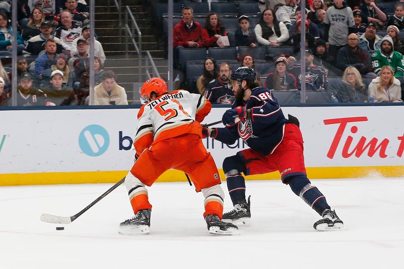 Dec 16, 2025; Columbus, Ohio, USA; Anaheim Ducks defenseman Olen Zellweger (51) takes the puck away from the stick of Columbus Blue Jackets right wing Kirill Marchenko (86) during overtime at Nationwide Arena. Mandatory Credit: Russell LaBounty-Imagn Images