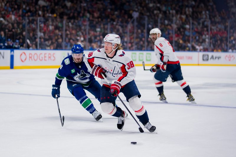 Mar 16, 2024; Vancouver, British Columbia, CAN; Washington Capitals defenseman Rasmus Sandin (38) drives past Vancouver Canucks forward J.T. Miller (9) in the second period at Rogers Arena. Mandatory Credit: Bob Frid-USA TODAY Sports