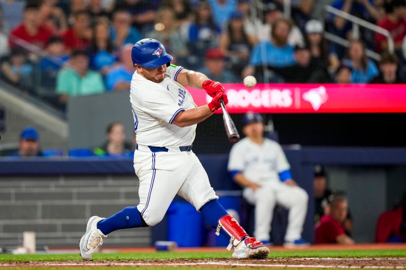 Jun 29, 2024; Toronto, Ontario, CAN; Toronto Blue Jays catcher Alejandro Kirk (30) hits a double against the New York Yankees during the fourth inning at Rogers Centre. Mandatory Credit: Kevin Sousa-USA TODAY Sports