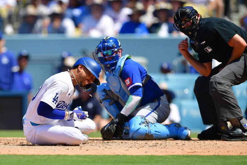 Jun 16, 2024; Los Angeles, California, USA; Los Angeles Dodgers shortstop Mookie Betts (50) reacts after being hit by pitch from Kansas City Royals pitcher Dan Altavilla (54) during the seventh inning at Dodger Stadium. Mandatory Credit: Gary A. Vasquez-USA TODAY Sports