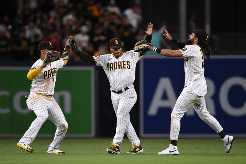 Jul 5, 2023; San Diego, California, USA; San Diego Padres right fielder Fernando Tatis Jr. (right) celebrates on the field with  center fielder Trent Grisham (center) and left fielder Juan Soto (left) after defeating the Los Angeles Angels at Petco Park. Mandatory Credit: Orlando Ramirez-USA TODAY Sports