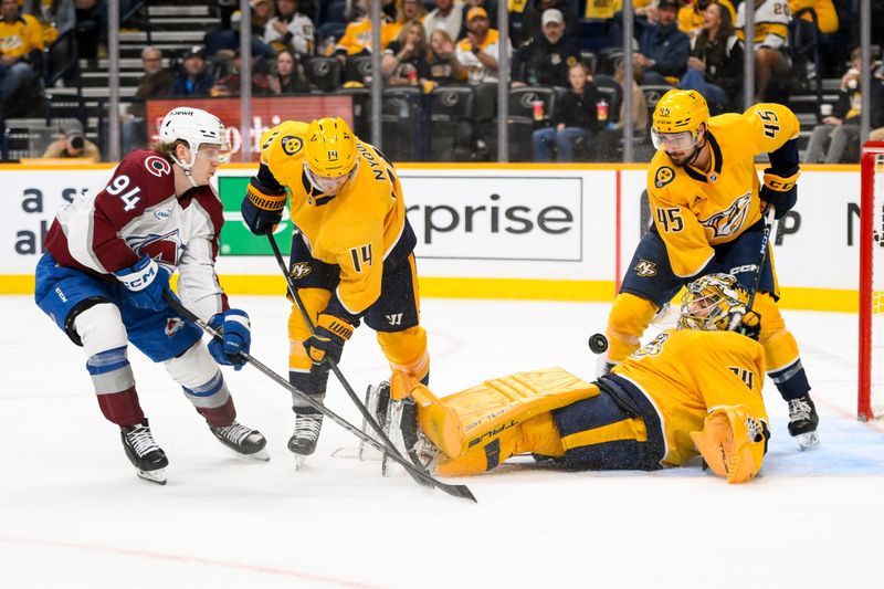 Nov 2, 2024; Nashville, Tennessee, USA;  Nashville Predators goaltender Juuse Saros (74) and center Gustav Nyquist (14) blocks the shot of Colorado Avalanche left wing Joel Kiviranta (94) during the second period at Bridgestone Arena. Mandatory Credit: Steve Roberts-Imagn Images