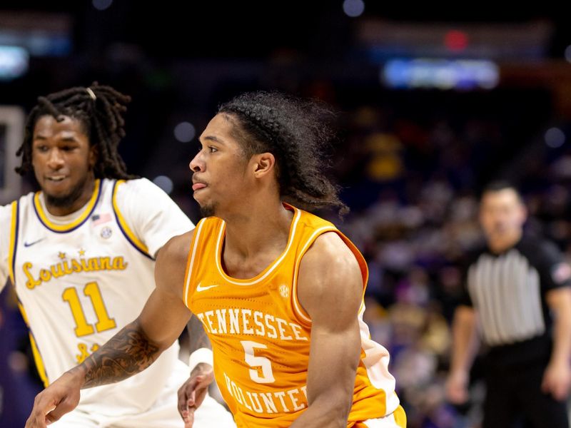 Jan 21, 2023; Baton Rouge, Louisiana, USA;  Tennessee Volunteers guard Zakai Zeigler (5) dribbles the ball against LSU Tigers guard Justice Williams (11) during the second half at Pete Maravich Assembly Center. Mandatory Credit: Stephen Lew-USA TODAY Sports