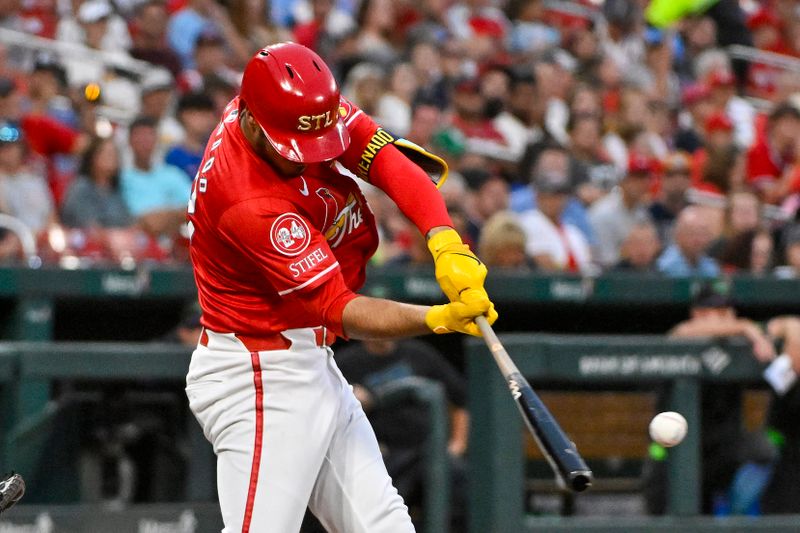 Aug 7, 2024; St. Louis, Missouri, USA;  St. Louis Cardinals third baseman Nolan Arenado (28) hits a two run single against the Tampa Bay Rays during the third inning at Busch Stadium. Mandatory Credit: Jeff Curry-USA TODAY Sports