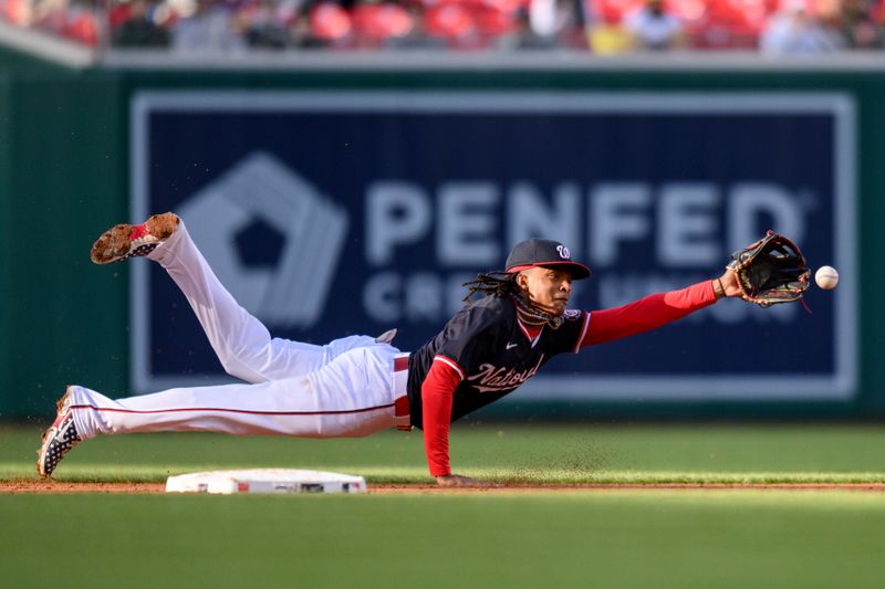 Apr 4, 2024; Washington, District of Columbia, USA; Washington Nationals shortstop CJ Abrams (5) dives for a ball during the second inning against the Pittsburgh Pirates at Nationals Park. Mandatory Credit: Reggie Hildred-USA TODAY Sports