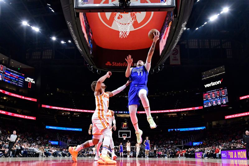 ATLANTA, GA - JANUARY 26: Luka Doncic #77 of the Dallas Mavericks drives to the basket during the game against the Atlanta Hawks on January 26, 2024 at State Farm Arena in Atlanta, Georgia.  NOTE TO USER: User expressly acknowledges and agrees that, by downloading and/or using this Photograph, user is consenting to the terms and conditions of the Getty Images License Agreement. Mandatory Copyright Notice: Copyright 2024 NBAE (Photo by Adam Hagy/NBAE via Getty Images)