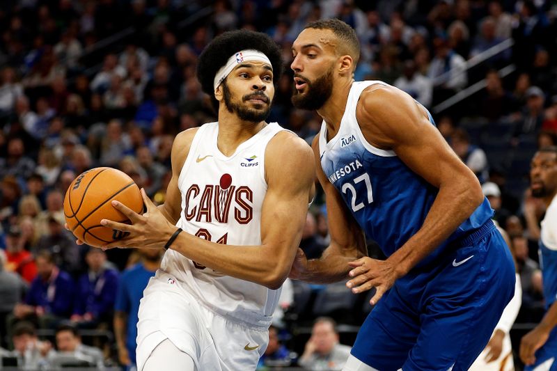 MINNEAPOLIS, MINNESOTA - MARCH 22: Jarrett Allen #31 of the Cleveland Cavaliers drives to the basket against Rudy Gobert #27 of the Minnesota Timberwolves in the third quarter at Target Center on March 22, 2024 in Minneapolis, Minnesota. The Timberwolves defeated the Cavaliers 104-91. NOTE TO USER: User expressly acknowledges and agrees that, by downloading and or using this photograph, User is consenting to the terms and conditions of the Getty Images License Agreement. (Photo by David Berding/Getty Images)