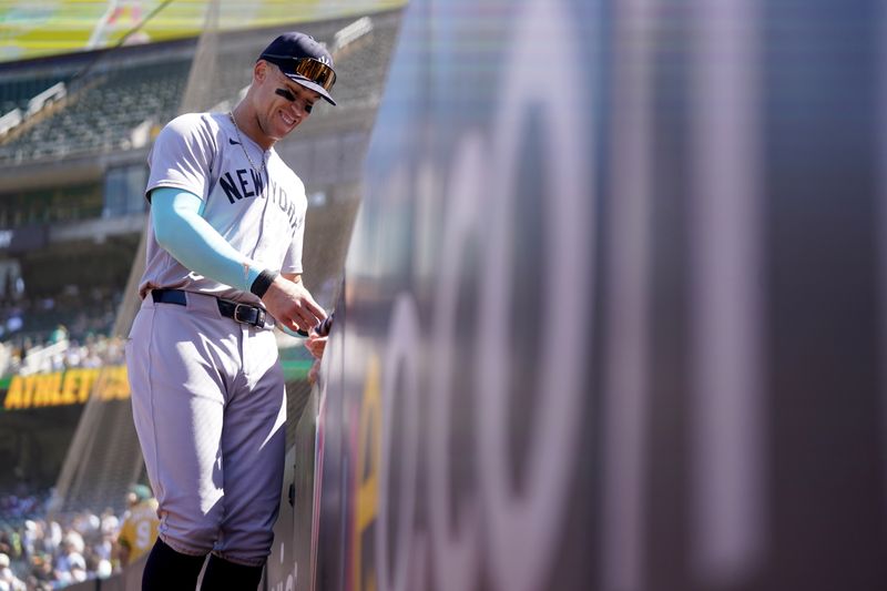 Sep 22, 2024; Oakland, California, USA; New York Yankees center fielder Aaron Judge (99) signs autographs before the start of the game against the Oakland Athletics at the Oakland-Alameda County Coliseum. Mandatory Credit: Cary Edmondson-Imagn Images