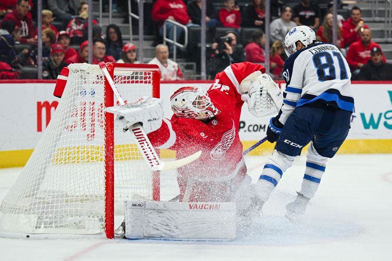 Oct 30, 2024; Detroit, Michigan, USA; Winnipeg Jets left wing Kyle Connor (81) scores a goal as Detroit Red Wings goaltender Alex Lyon (34) tends the net during the first period at Little Caesars Arena. Mandatory Credit: Tim Fuller-Imagn Images