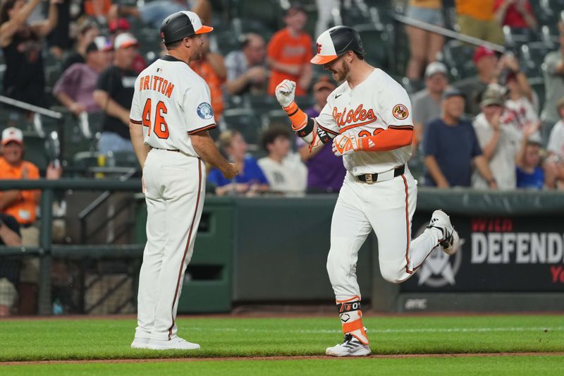Jun 24, 2025; Baltimore, Maryland, USA; Baltimore Orioles designated hitter Ryan O’Hearn (32) is greeted by coach Buck Britton (46) following his solo home run during the seventh inning against the Texas Rangers at Oriole Park at Camden Yards. Mandatory Credit: Mitch Stringer-Imagn Images