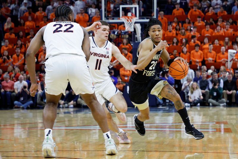 Feb 17, 2024; Charlottesville, Virginia, USA; Wake Forest Demon Deacons guard Hunter Sallis (23) drives to the basket as Virginia Cavaliers guard Isaac McKneely (11) defends in the first half at John Paul Jones Arena. Mandatory Credit: Geoff Burke-USA TODAY Sports