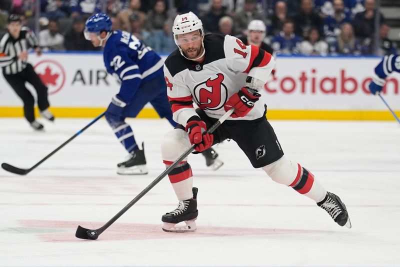 Oct 21, 2025; Toronto, Ontario, CAN; New Jersey Devils forward Luke Glendening (14) carries the puck against the Toronto Maple Leafs during the second period at Scotiabank Arena. Mandatory Credit: John E. Sokolowski-Imagn Images