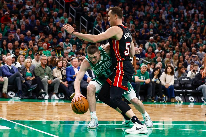 BOSTON, MA - APRIL 24: Payton Pritchard #11 of the Boston Celtics can't find a way around Duncan Robinson #55 of the Miami Heat during the third quarter of game two of the Eastern Conference First Round Playoffs at TD Garden on April 24, 2024 in Boston, Massachusetts. NOTE TO USER: User expressly acknowledges and agrees that, by downloading and/or using this Photograph, user is consenting to the terms and conditions of the Getty Images License Agreement. (Photo By Winslow Townson/Getty Images)