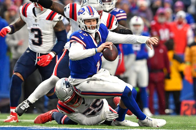 Buffalo Bills quarterback Josh Allen is sacked by New England Patriots linebacker Josh Uche (55) during the second half of an NFL football game in Orchard Park, N.Y., Sunday, Dec. 31, 2023. (AP Photo/Adrian Kraus)