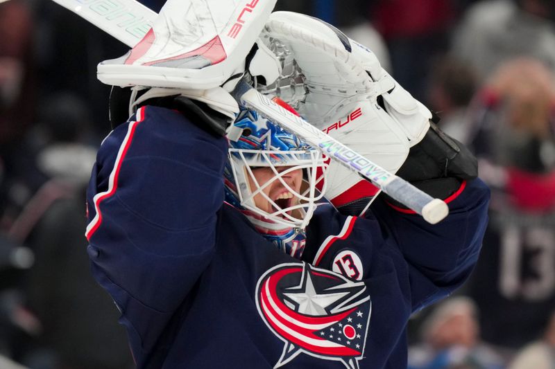 Nov 29, 2024; Columbus, Ohio, USA;  Columbus Blue Jackets goaltender Elvis Merzlikins (90) adjusts his helmet during a stop in play against the Calgary Flames in the third period at Nationwide Arena. Mandatory Credit: Aaron Doster-Imagn Images