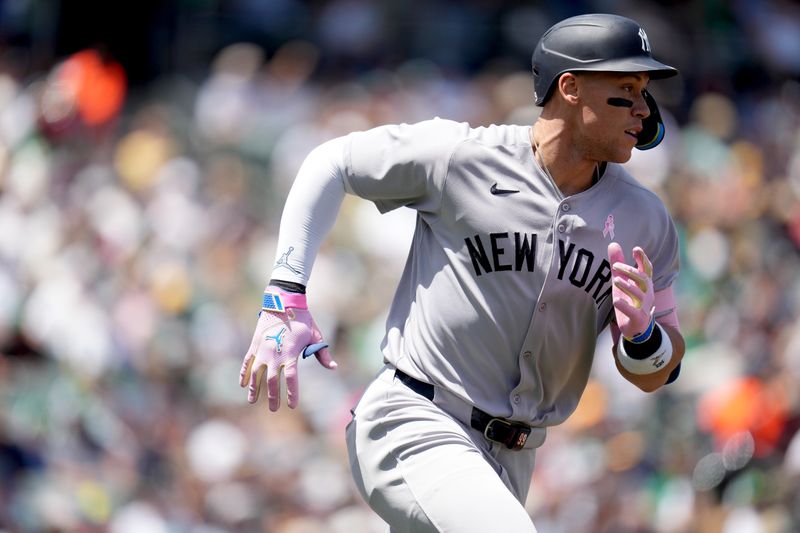 May 11, 2025; West Sacramento, California, USA; New York Yankees right fielder Aaron Judge (99) runs towards first after hitting an RBI single against the Athletics in the second inning at Sutter Health Park. Mandatory Credit: Cary Edmondson-Imagn Images