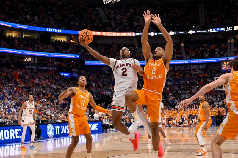 Mar 15, 2025; Nashville, TN, USA;  Auburn Tigers guard Denver Jones (2) goes up for a shot as Tennessee Volunteers guard Chaz Lanier (2) defends during the second half at Bridgestone Arena. Mandatory Credit: Steve Roberts-Imagn Images