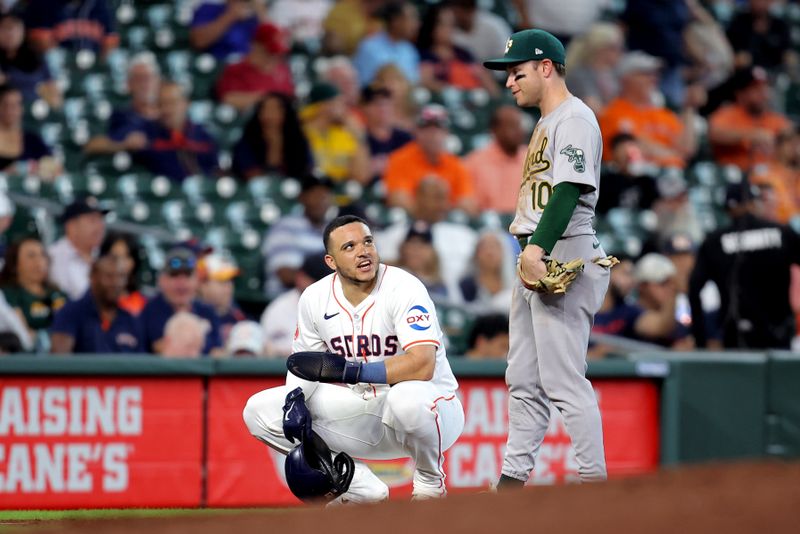 Sep 12, 2024; Houston, Texas, USA; Houston Astros catcher Yainer Diaz (21) talks with Oakland Athletics third baseman Nick Allen (10) during a break in the action during the third inning at Minute Maid Park. Mandatory Credit: Erik Williams-Imagn Images