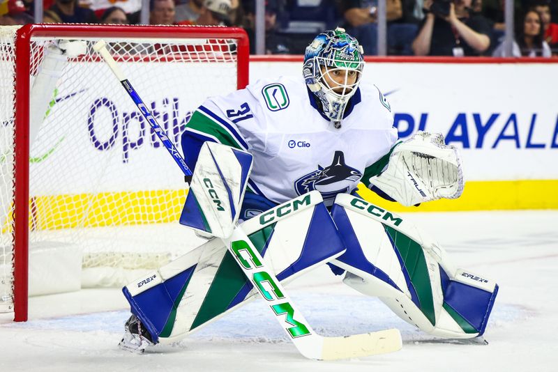 Sep 28, 2024; Calgary, Alberta, CAN; Vancouver Canucks goaltender Arturs Silovs (31) guards his net against the Calgary Flames during the second period at Scotiabank Saddledome. Mandatory Credit: Sergei Belski-Imagn Images