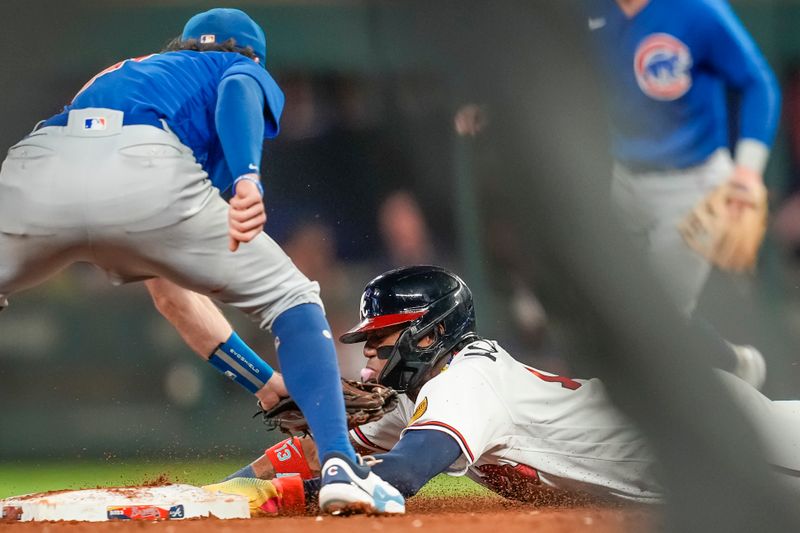 Sep 27, 2023; Cumberland, Georgia, USA; Atlanta Braves right fielder Ronald Acuna Jr. (13) steals a base against the Chicago Cubs during the eighth inning at Truist Park. Mandatory Credit: Dale Zanine-USA TODAY Sports