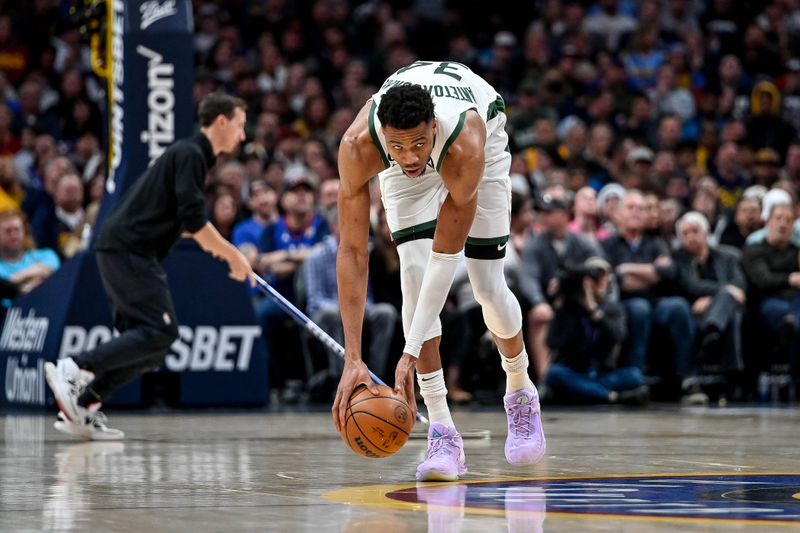 DENVER, CO - MARCH 25:  Giannis Antetokounmpo #34 of the Milwaukee Bucks dribbles in a game against the Denver Nuggets at Ball Arena on March 25, 2023 in Denver, Colorado. NOTE TO USER: User expressly acknowledges and agrees that, by downloading and or using this photograph, User is consenting to the terms and conditions of the Getty Images License Agreement. (Photo by Dustin Bradford/Getty Images)