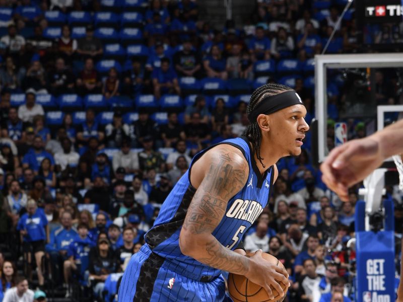 ORLANDO, FL - APRIL 27: Paolo Banchero #5 of the Orlando Magic looks to pass the ball during the game against the Cleveland Cavaliers during Round 1 Game 4 of the 2024 NBA Playoffs on April 27, 2024 at the Kia Center in Orlando, Florida. NOTE TO USER: User expressly acknowledges and agrees that, by downloading and or using this photograph, User is consenting to the terms and conditions of the Getty Images License Agreement. Mandatory Copyright Notice: Copyright 2024 NBAE (Photo by Fernando Medina/NBAE via Getty Images)