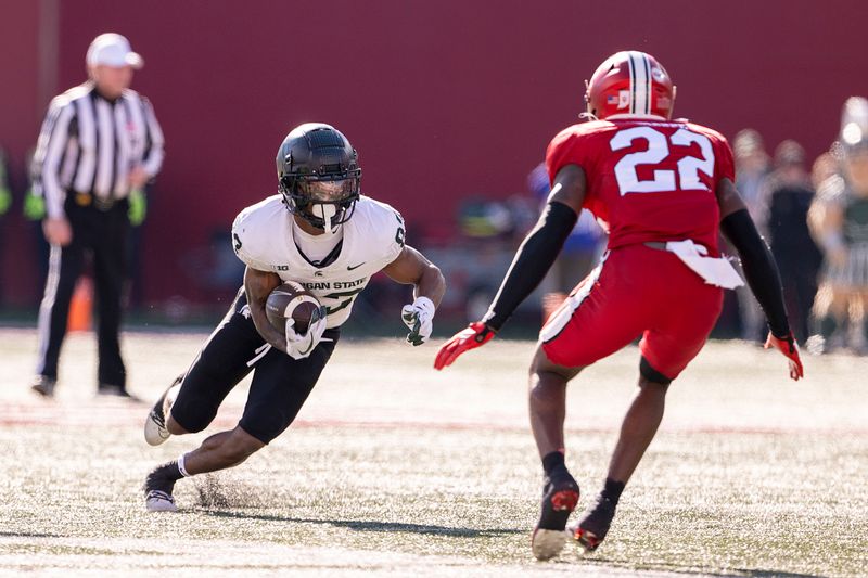 Nov 18, 2023; Bloomington, Indiana, USA; Michigan State Spartans wide receiver Montorie Foster Jr. (83) looks to get past Indiana Hoosiers defensive back Jamari Sharpe (22) during the second quarter  at Memorial Stadium. Mandatory Credit: Marc Lebryk-USA TODAY Sports