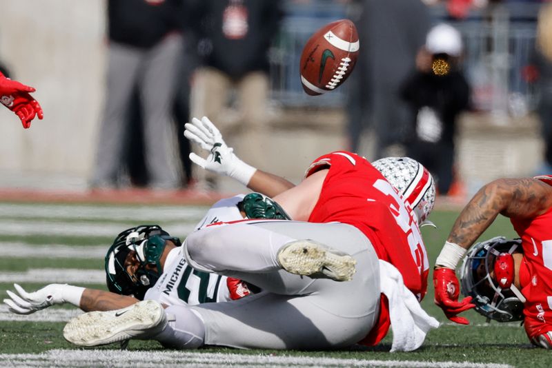 Nov 20, 2021; Columbus, Ohio, USA;  Michigan State Spartans running back Jordon Simmons (22) fumbles in the first half against the Ohio State Buckeyes at Ohio Stadium. Mandatory Credit: Rick Osentoski-USA TODAY Sports