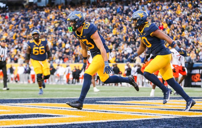 Oct 21, 2023; Morgantown, West Virginia, USA; West Virginia Mountaineers wide receiver EJ Horton (13) celebrates after catching a pass for a touchdown during the third quarter against the Oklahoma State Cowboys at Mountaineer Field at Milan Puskar Stadium. Mandatory Credit: Ben Queen-USA TODAY Sports