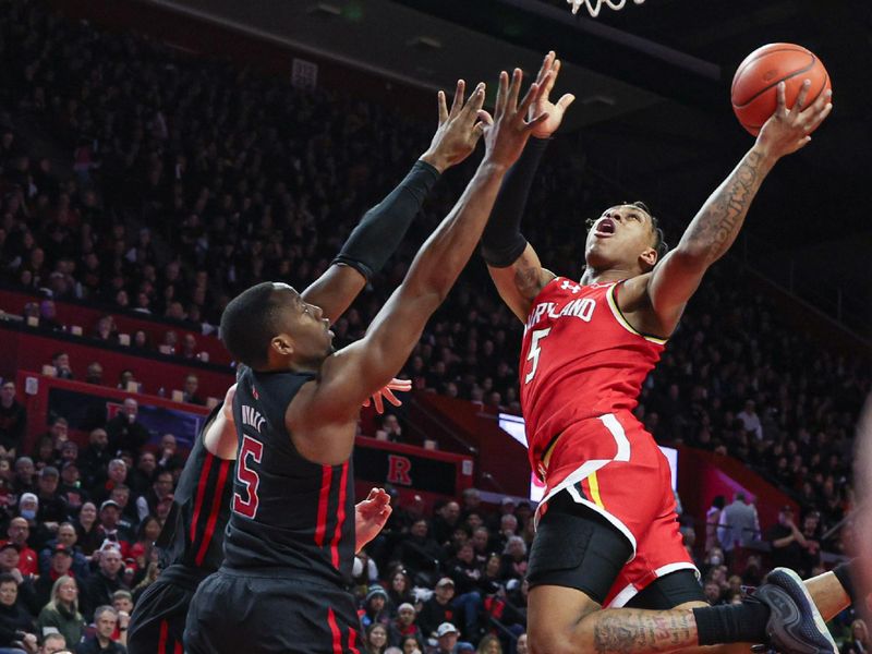 Feb 25, 2024; Piscataway, New Jersey, USA; Maryland Terrapins guard DeShawn Harris-Smith (5) drives for a shot as Rutgers Scarlet Knights forward Aundre Hyatt (5) defends during the first half at Jersey Mike's Arena. Mandatory Credit: Vincent Carchietta-USA TODAY Sports