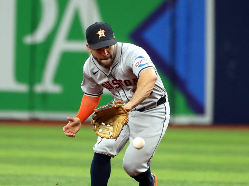 Aug 14, 2024; St. Petersburg, Florida, USA;  Houston Astros second base Jose Altuve (27) fields the ball against the Tampa Bay Rays during the second inning at Tropicana Field. Mandatory Credit: Kim Klement Neitzel-USA TODAY Sports