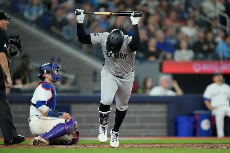 Apr 16, 2024; Toronto, Ontario, CAN; New York Yankees right fielder Juan Soto (22) throws his bat after flying out during the eighth inning against the Toronto Blue Jays at Rogers Centre. Mandatory Credit: John E. Sokolowski-USA TODAY Sports