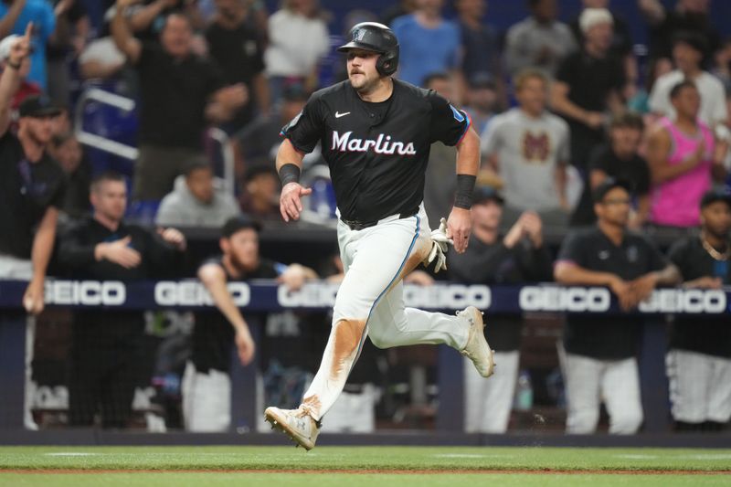 Jun 7, 2024; Miami, Florida, USA;  Miami Marlins first baseman Jake Burger (36) scores a run in the eight inning against the Cleveland Guardians at loanDepot Park. Mandatory Credit: Jim Rassol-USA TODAY Sports