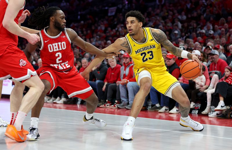 Feb 8, 2026; Columbus, Ohio, USA;  Michigan Wolverines forward Yaxel Lendeborg (23) sets the play as Ohio State Buckeyes guard Bruce Thornton (2) defends during the first half at Value City Arena. Mandatory Credit: Joseph Maiorana-Imagn Images