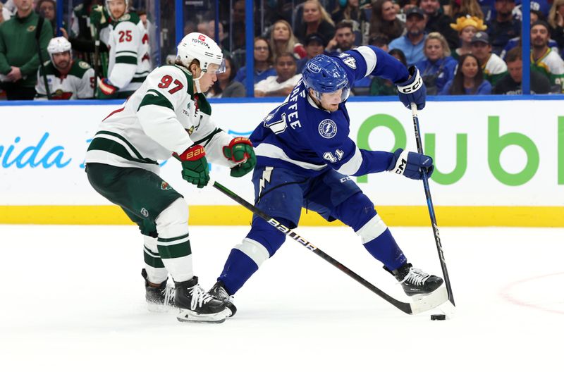 Oct 24, 2024; Tampa, Florida, USA; Minnesota Wild left wing Kirill Kaprizov (97) defends Tampa Bay Lightning right wing Mitchell Chaffee (41) during the third period at Amalie Arena. Mandatory Credit: Kim Klement Neitzel-Imagn Images