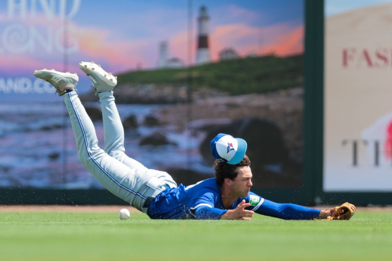 Mar 15, 2025; Jupiter, Florida, USA; Toronto Blue Jays center fielder Joey Loperfido (10) dives but cannot make a catch against St. Louis Cardinals shortstop Masyn Winn (not picutred) during the first inning at Roger Dean Chevrolet Stadium. Mandatory Credit: Sam Navarro-Imagn Images