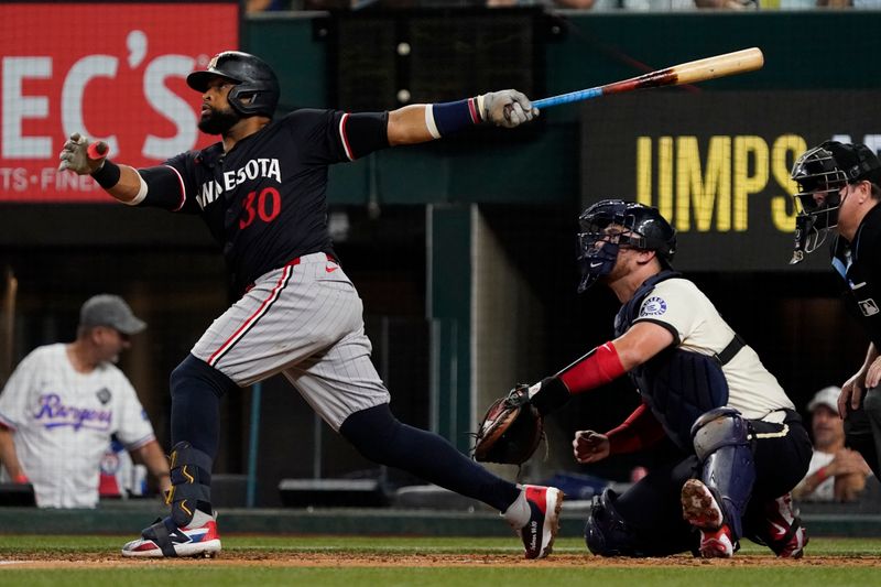 Aug 16, 2024; Arlington, Texas, USA; Minnesota Twins first baseman Carlos Santana (30) follows through on a three-run home run during the fifth inning against the Texas Rangers at Globe Life Field. Mandatory Credit: Raymond Carlin III-USA TODAY Sports