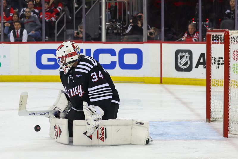 Mar 23, 2024; Newark, New Jersey, USA; New Jersey Devils goaltender Jake Allen (34) makes a save against the Ottawa Senators during the third period at Prudential Center. Mandatory Credit: Ed Mulholland-USA TODAY Sports