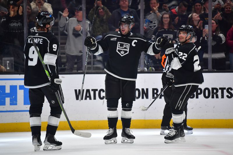 Mar 20, 2024; Los Angeles, California, USA; Los Angeles Kings center Anze Kopitar (11) celebrates his goal scored against the Minnesota Wild with right wing Adrian Kempe (9) and left wing Kevin Fiala (22) during the second period at Crypto.com Arena. Mandatory Credit: Gary A. Vasquez-USA TODAY Sports